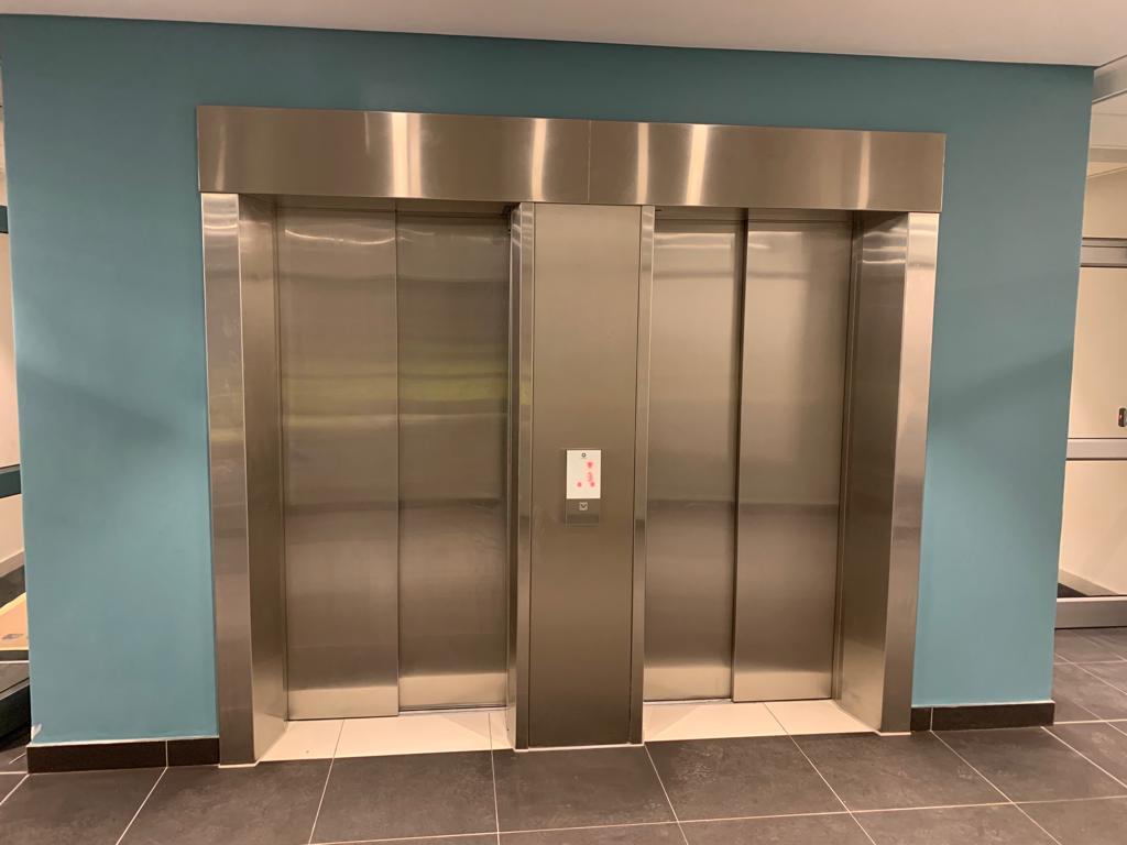 Modern elevator interior with sleek design and advanced controls